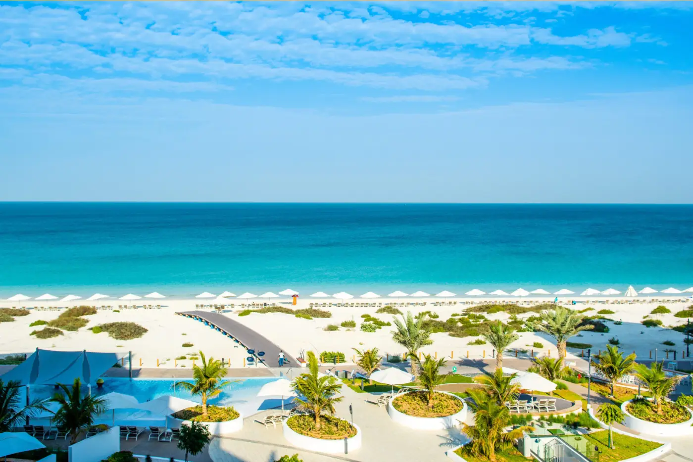Aerial view of the white-sand beach and turquoise water on Saadiyat Island