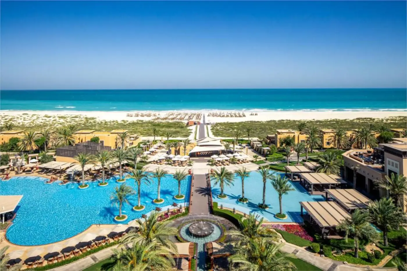 Beachfront resort pools and palm gardens on Saadiyat Beach
